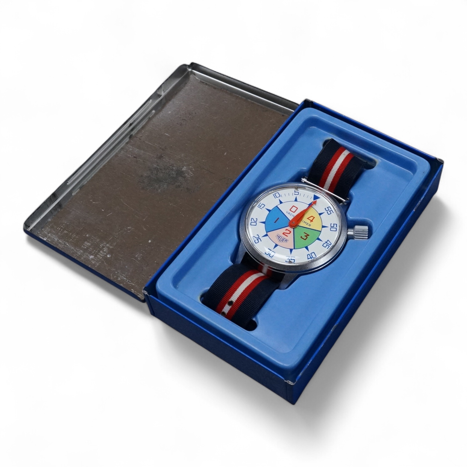 A 1970's steel cased Heuer Yacht Timer wrist stop watch, with polychrome dial, on a fabric strap, case diameter 52mm, with original Heuer tin box.